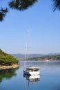 Racing yacht in the sea on blue sky background. Peaceful seascape. Beautiful blue sky over calm sea.