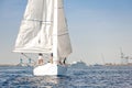 Racing yacht with white sails in a calm sea