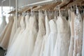 a rack of aline wedding dresses in a clean store setting