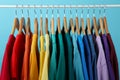 Rack with bright clothes on background. Rainbow colors Royalty Free Stock Photo