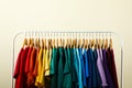 Rack with bright clothes on background. Rainbow colors Royalty Free Stock Photo