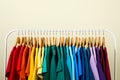 Rack with bright clothes on background. Rainbow colors Royalty Free Stock Photo