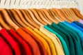 Rack with bright clothes on background. Rainbow colors Royalty Free Stock Photo