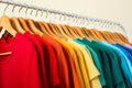 Rack with bright clothes on background. Rainbow colors Royalty Free Stock Photo