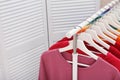 Rack with bright clothes in room Royalty Free Stock Photo