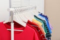 Rack with bright clothes in room Royalty Free Stock Photo