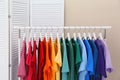 Rack with bright clothes in room Royalty Free Stock Photo