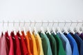 Rack with bright clothes on white background Royalty Free Stock Photo