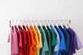 Rack with bright clothes on white background Royalty Free Stock Photo