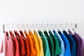 Rack with bright clothes on white background Royalty Free Stock Photo