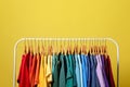 Rack with bright clothes on background. Rainbow colors Royalty Free Stock Photo