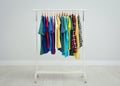 Rack with bright clothes in room Royalty Free Stock Photo