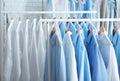 Rack with clean clothes on hangers after dry-cleaning Royalty Free Stock Photo