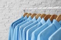 Rack with clean clothes on hangers after dry-cleaning Royalty Free Stock Photo