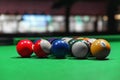 A rack of colorful billiard balls on a green pool table felt Royalty Free Stock Photo