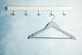 Rack with empty clothes hanger on color wall. Wardrobe accessory Royalty Free Stock Photo
