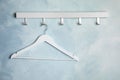 Rack with empty clothes hanger on color wall. Wardrobe accessory Royalty Free Stock Photo