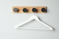 Rack with empty clothes hanger on white wall Royalty Free Stock Photo