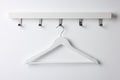Rack with empty clothes hanger on white wall Royalty Free Stock Photo