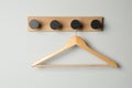 Rack with empty wooden clothes hanger on white wall Royalty Free Stock Photo