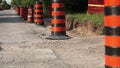 Rack focus long line row of orange and black traffic delineator pylon barrels