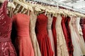 rack full of sleeveless and offshoulder evening gowns in a retail shop