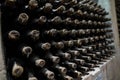 Rack full of wine bottles aging in wine cellar