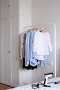 Rack with hanging clothes in the interior of the dressing room. Royalty Free Stock Photo