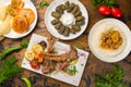 Rack of lamb, dolma with lamb, pilaf with beef, samsa, checkerbura, baklava top view on wooden table Royalty Free Stock Photo