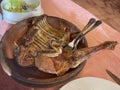 a rack of lamb and a leg of lamb roasted in a clay pot, traditional artisan food, cooked in a wood oven Royalty Free Stock Photo