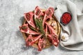 Rack of lamb , raw meat with bone, chops with salt, pepper. Gray background. Top view Royalty Free Stock Photo