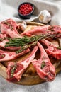 Rack of lamb , raw meat with bone, chops with salt, pepper. Gray background. Top view Royalty Free Stock Photo