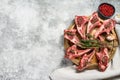 Rack of lamb , raw meat with bone, chops with salt, pepper. Gray background. Top view. Copy space Royalty Free Stock Photo