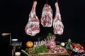 Rack of lamb , raw meat with bone on rustic kitchen table. Fresh raw butchers lamb beef cutlets with fresh rosemary on black Royalty Free Stock Photo