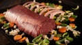 Rack of meat on hot plate with assorted vegetables