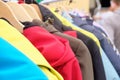 Rack with multicolored modern warm clothes in a store