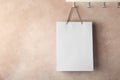 Rack with paper shopping bag on color wall. Royalty Free Stock Photo