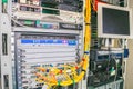 Rack with powerful Internet servers. The monitor is installed in a computer cabinet. A central router with multiple optical cables Royalty Free Stock Photo