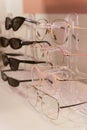 Rack with stylish trendy plastic glasses. Retail sale of stylish glasses