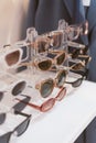 Rack with stylish trendy plastic glasses. Retail sale of stylish glasses