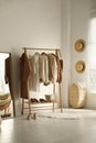 Rack with stylish women`s clothes in dressing room. Modern interior design Royalty Free Stock Photo