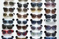 Rack with sunglasses in eyewear store Royalty Free Stock Photo