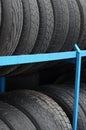 Rack with variety of car tires in automobile store. Many black tires. Tire stack background Royalty Free Stock Photo