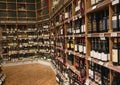 Rack with various bottles of wines on shelves in a wine shop. Royalty Free Stock Photo