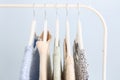 Rack with winter clothes on color background Royalty Free Stock Photo