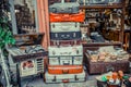 Racked suitcases in front of antique shop. colorful old suitcases.