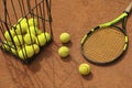 Racket and basket tennis balls on clay court Royalty Free Stock Photo