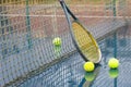 Racket leaning on net and wet tennis balls Royalty Free Stock Photo