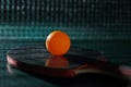 A racket and a ping-pong ball on the green table Royalty Free Stock Photo