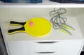 Rackets with a ball for beach tennis in the closet, a sports jump rope.